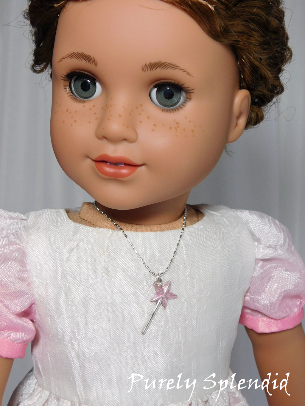 18 inch doll shown wearing a pink glitter wand
