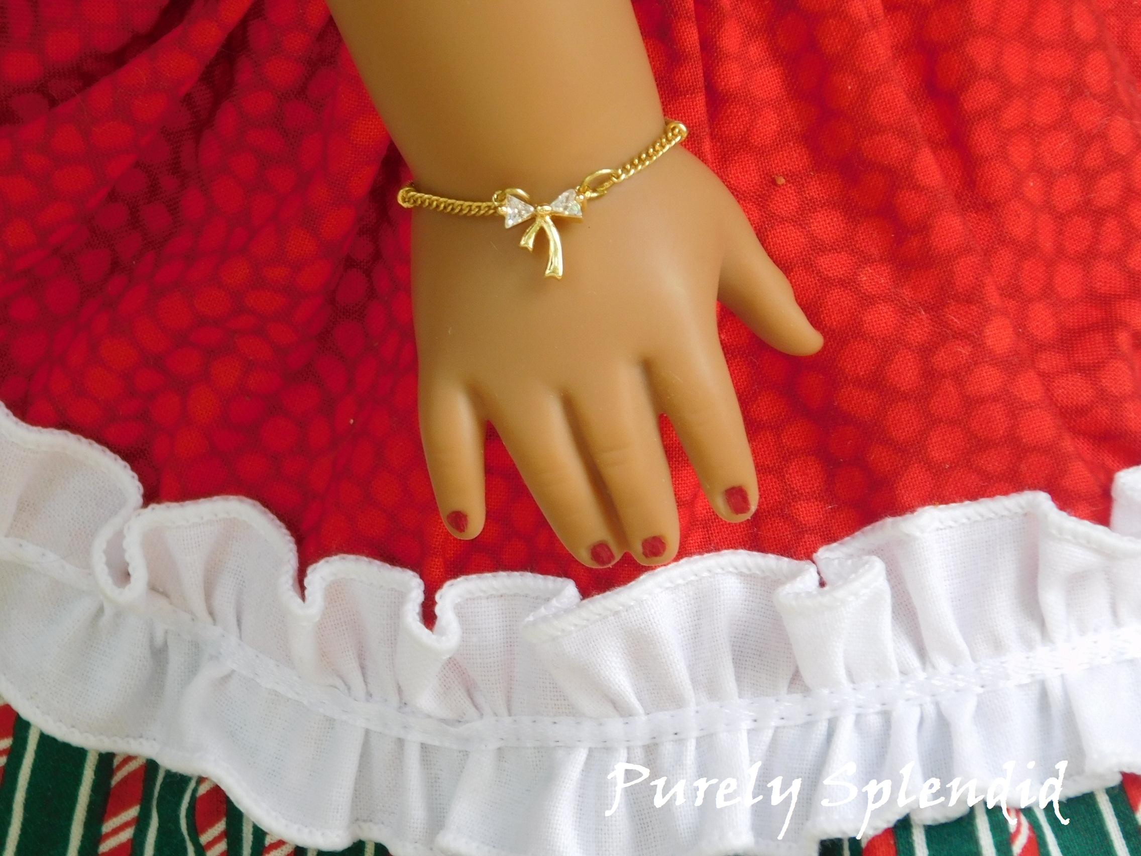Beautiful Gold Sparkling Bow on a simple gold chain shown on an 18 inch doll