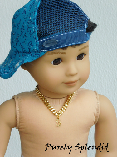 18 inch doll wearing a heavy gold chain with gold dollar sign charm