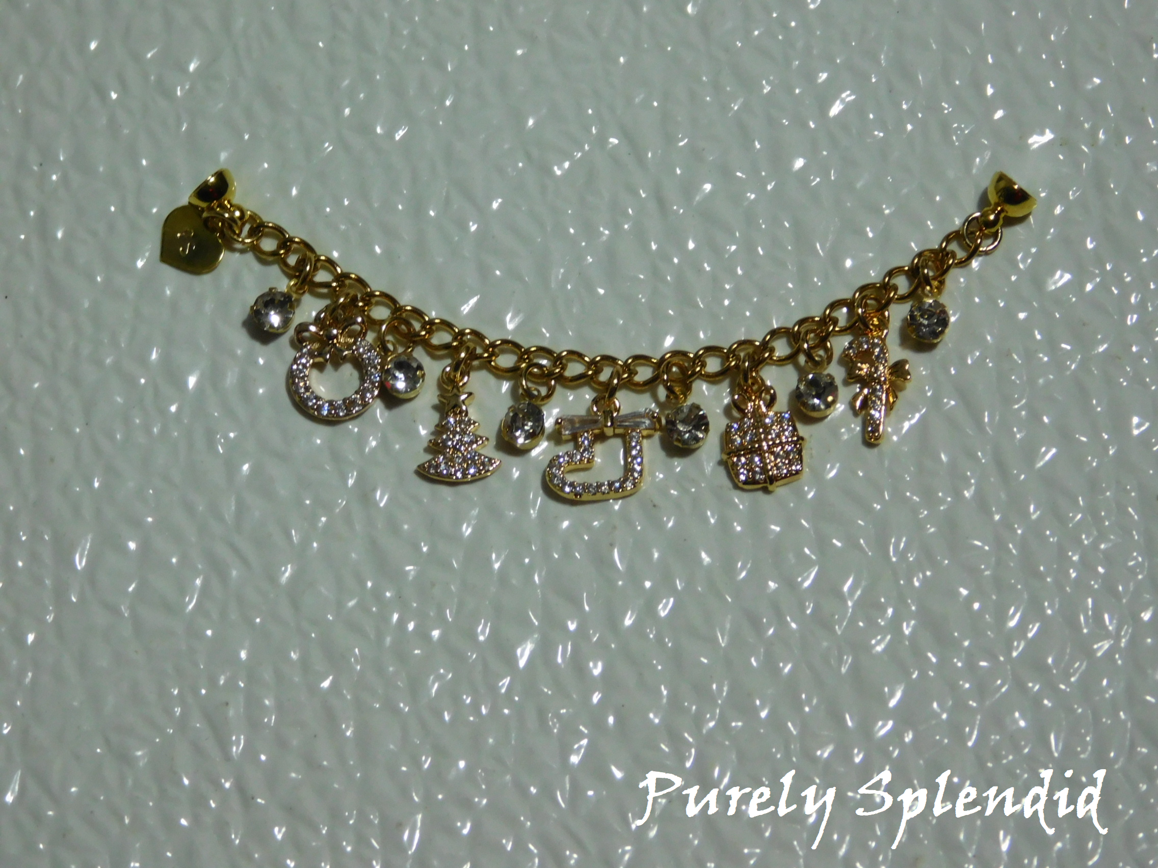 five Cubic Zirconia Charms and rhinestone drops on a gold charm bracelet for 18 inch dolls