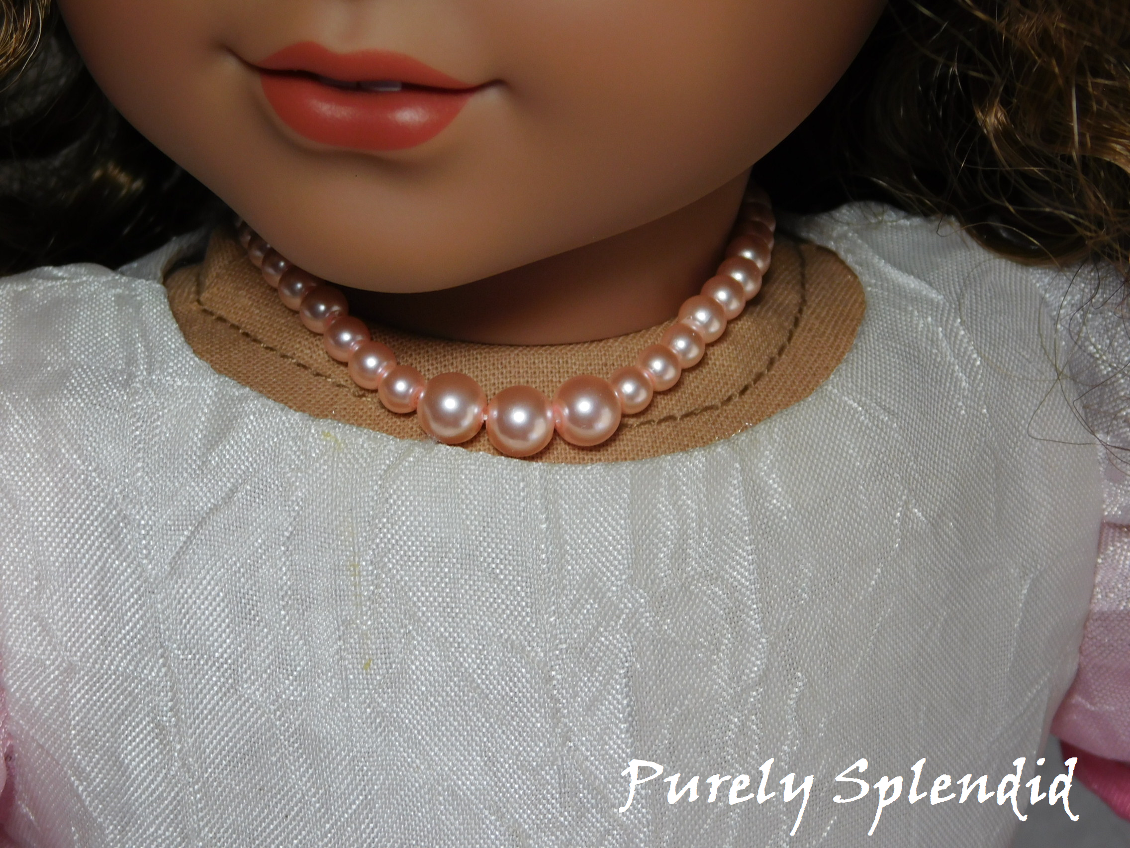 18 inch doll shown wearing a Graduated Pink Pearl Necklace