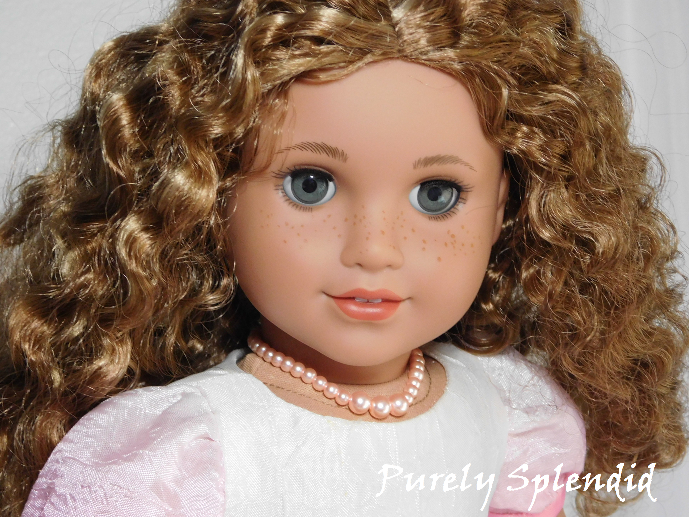 18 inch doll shown wearing a Graduated Pink Pearl Necklace