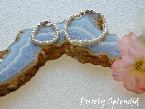 White Pearl Bracelet and Graduated White Pearl Necklace for 18 inch dolls displayed on a colorful piece of rock