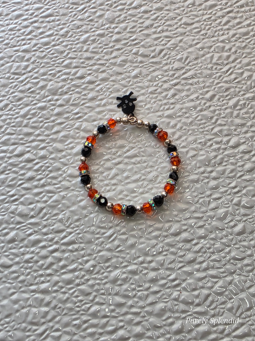 Orange and Black Sparkling Halloween Bracelet with lack skull and crossbones charm