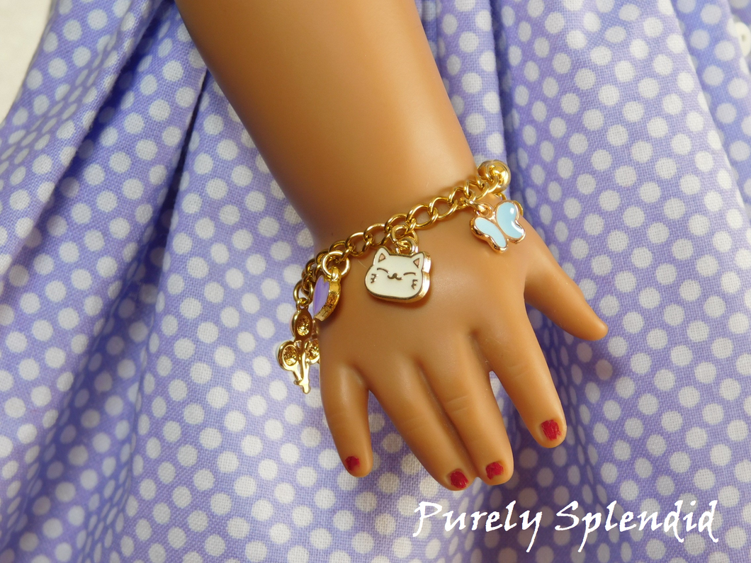 18 inch doll shown wearing a Happy Charm Bracelet with a white happy cat face, blue butterfly and purple heart charm