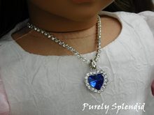 Load image into Gallery viewer, beautiful sparkling blue heart necklace on a rhinestone chain shown worn by an 18 inch doll
