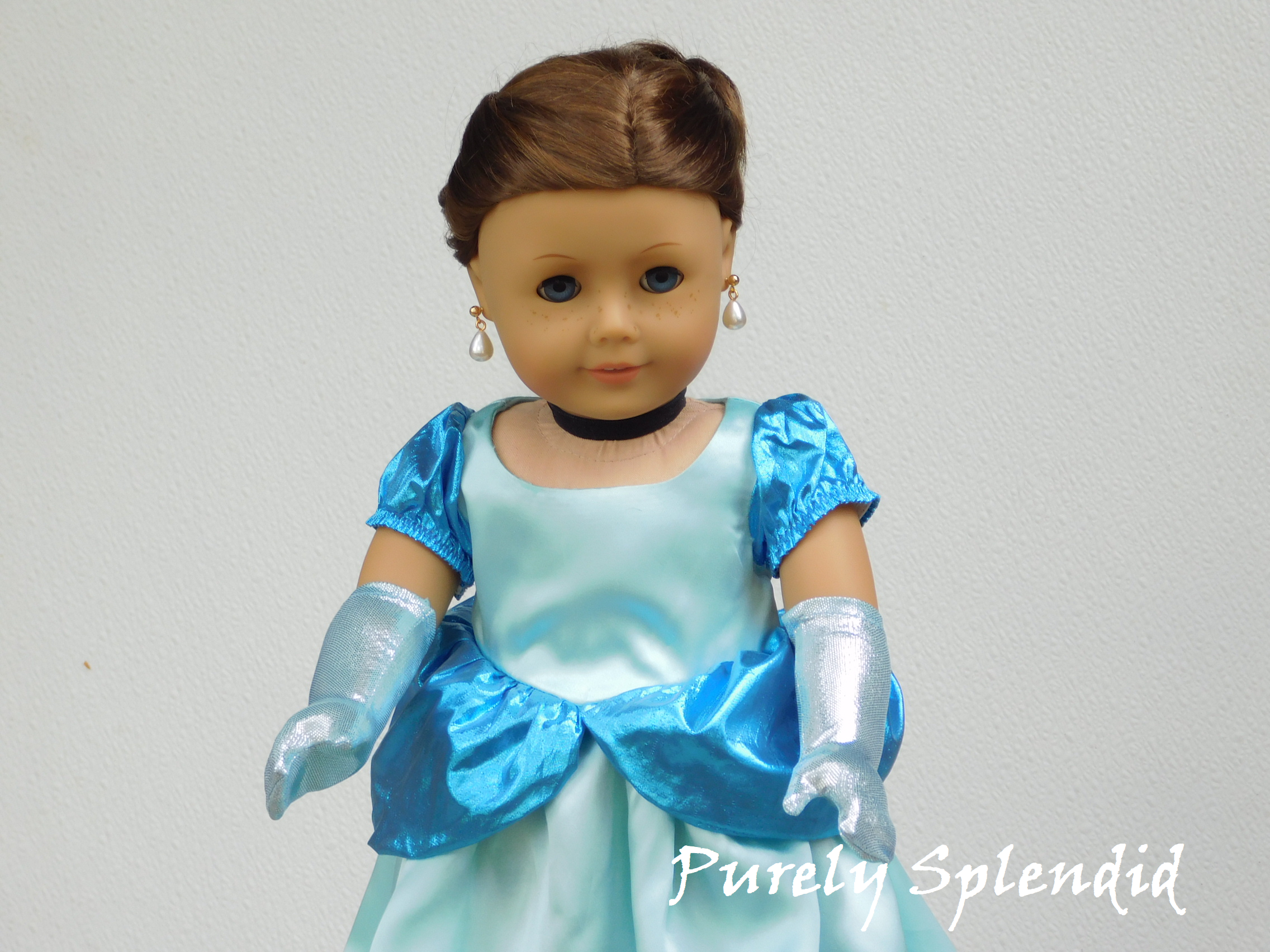18 inch doll shown wearing a pair of Icy Blue Gloves that come up to her elbows