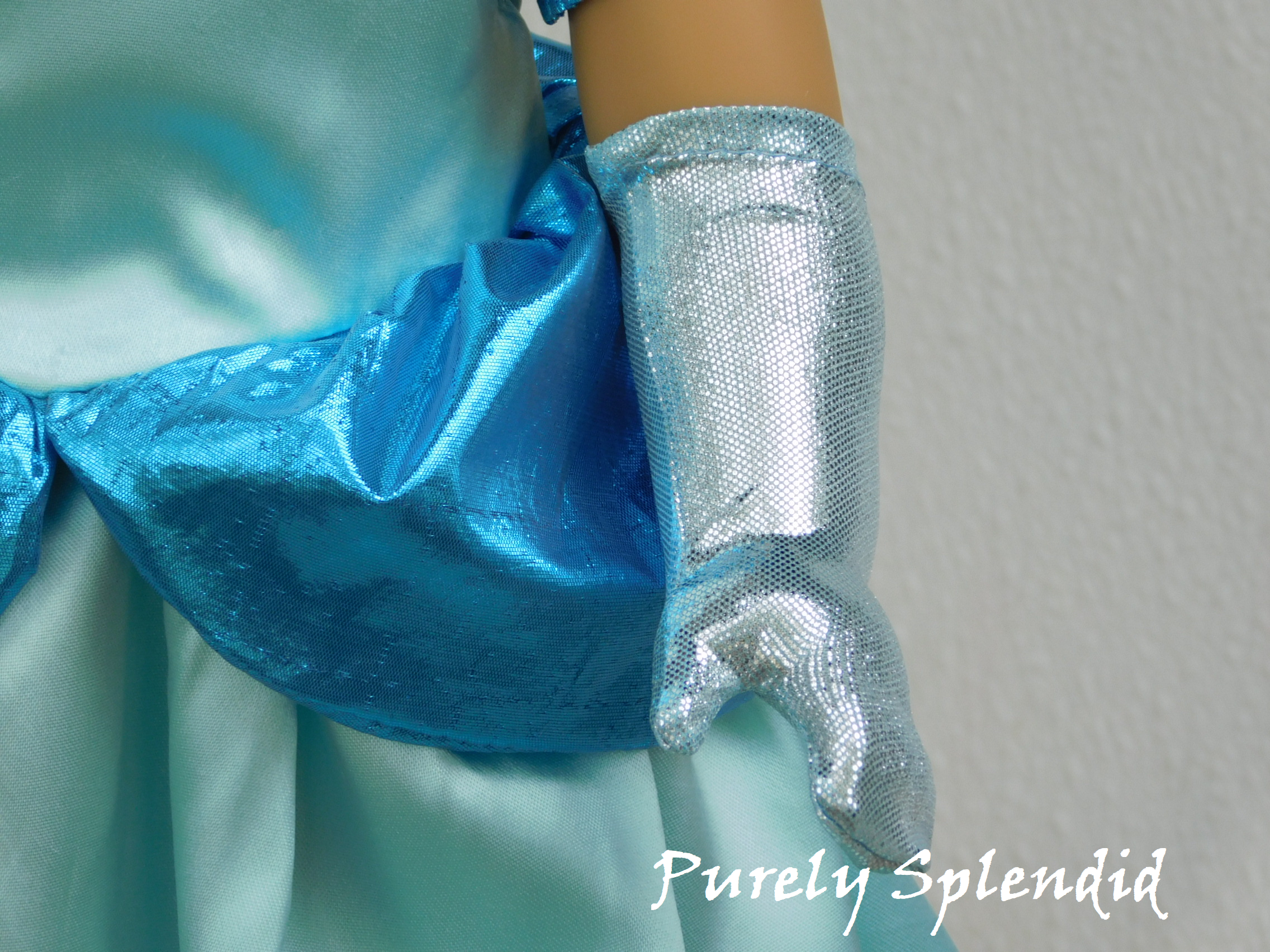 Icy Blue Glove shown on the left hand of an 18 inch doll