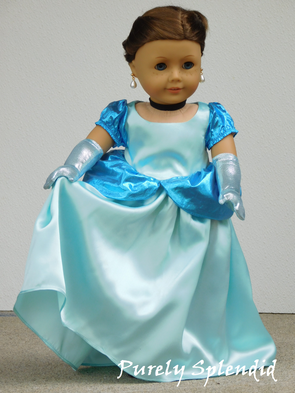 18 inch doll dressed as Cinderella wearing a pair of Icy Blue Gloves