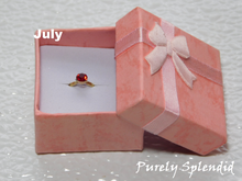 Load image into Gallery viewer, July Birthstone Ring for 18 inch dolls - Ruby colored crystal on a gold band
