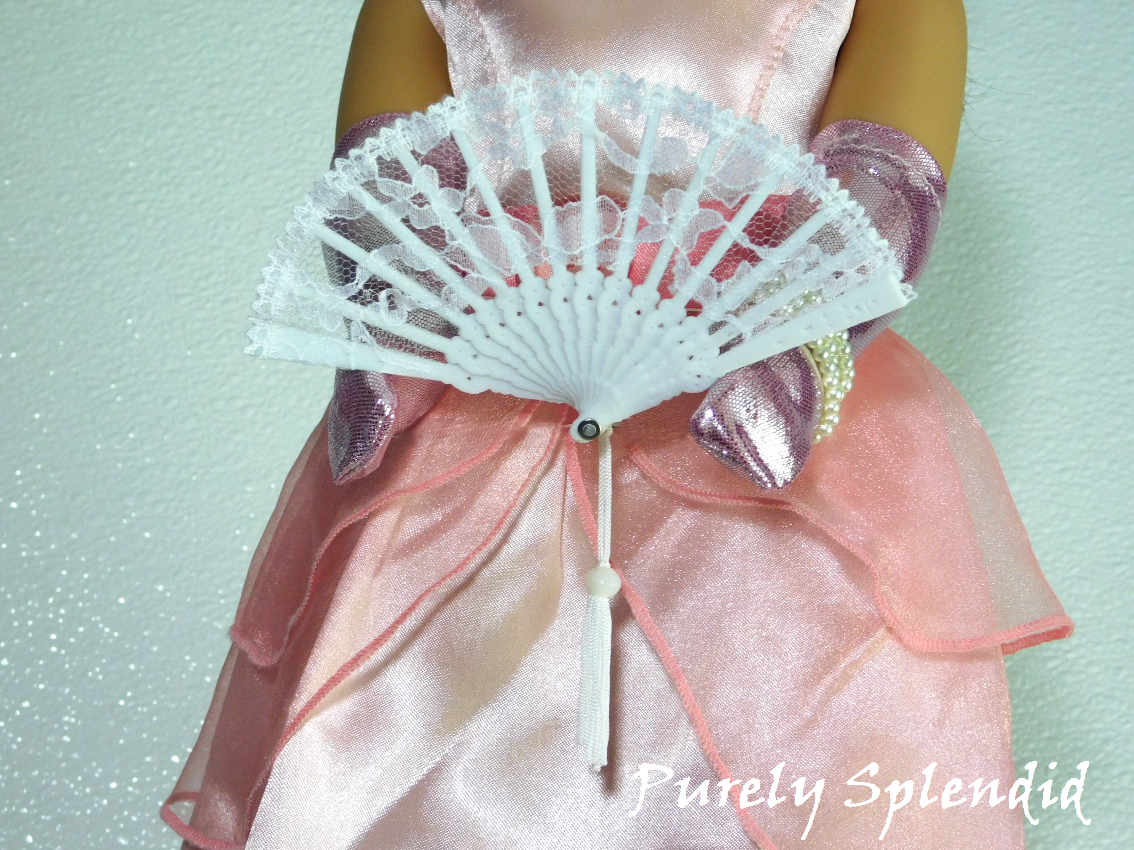 Lacy White Hand Fan with white tassel. Shown with an 18 inch doll