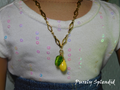18 inch doll wearing a decorative gold chain necklace with yellow lemon and green leaf hanging from it
