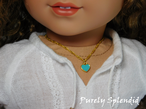 18 inch doll shown wearing a Teal Mini Heart Choker necklace - small teal heart on a twisted gold chain