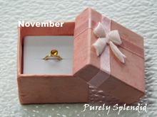 Load image into Gallery viewer, November Birthstone Ring for 18 inch dolls - topaz colored crystal on a gold band
