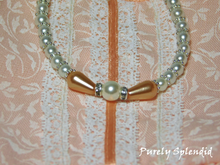 Load image into Gallery viewer, Peaches n Pearl Necklace with two teardrop shaped peach colored pearls set around a large round white pearl which is the focal point of a white pearl necklace
