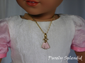 Pink Dress Necklace on a dainty gold chain worn by an 18 inch doll
