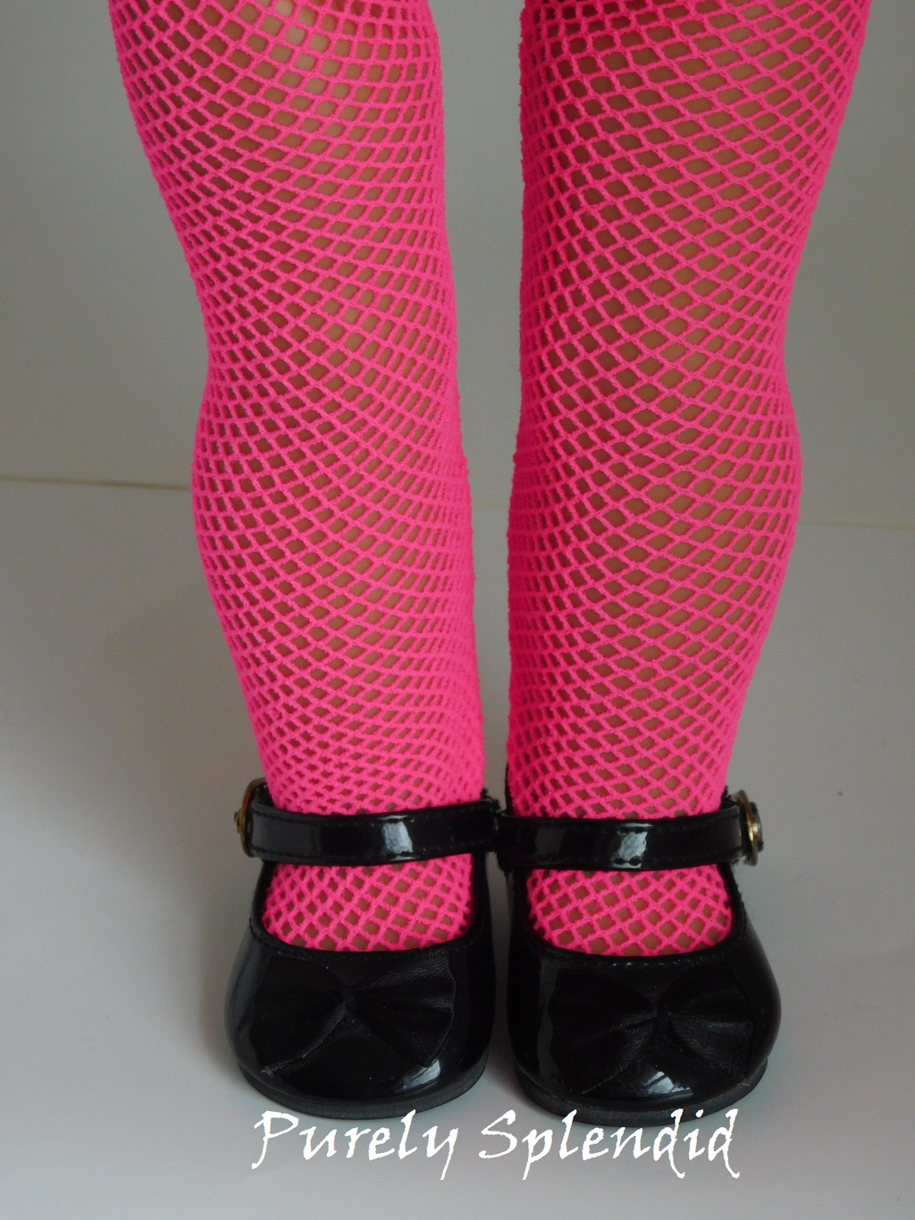 Pink Fishnet Tights shown on an 18 inch doll
