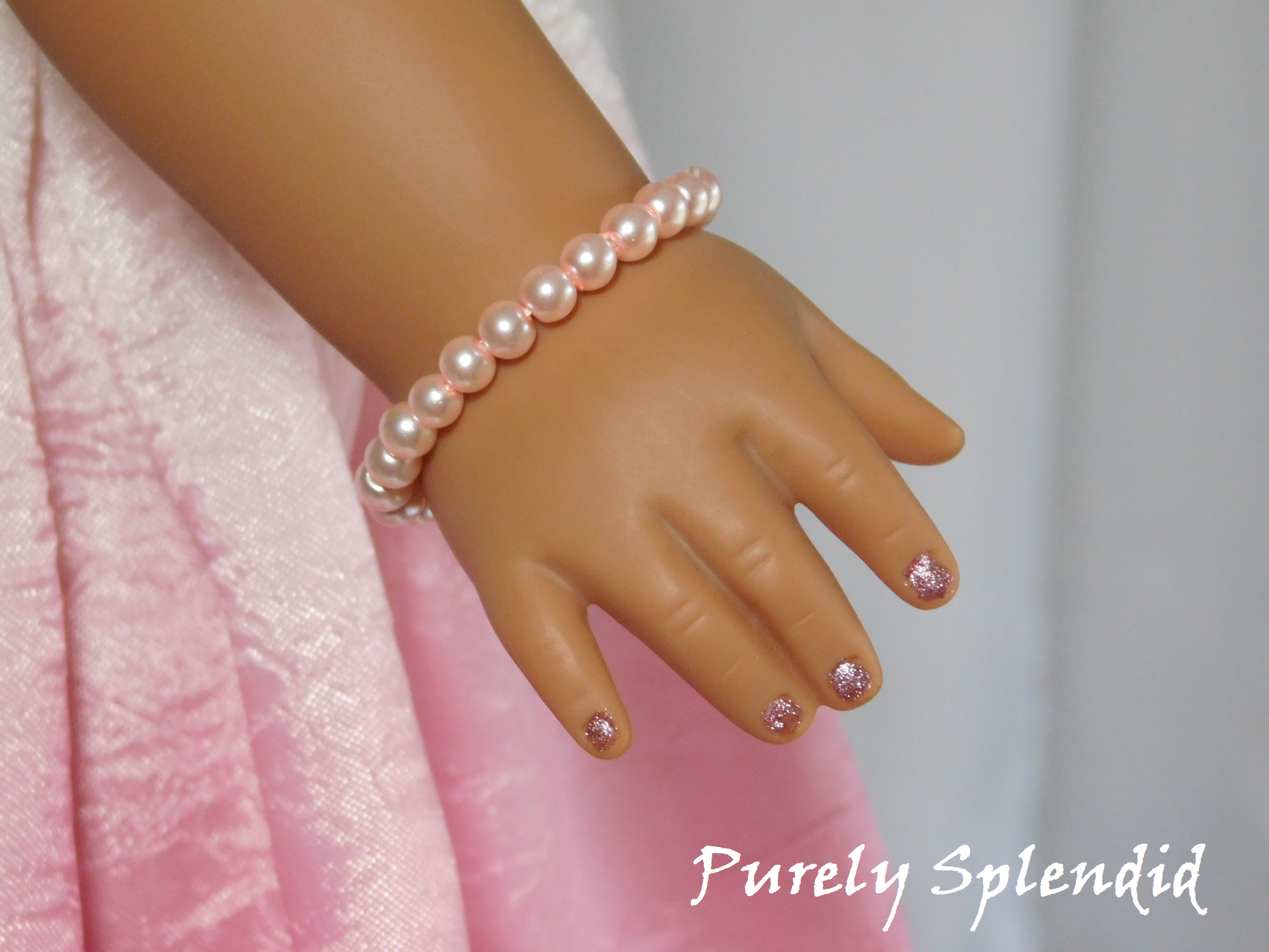 18 inch doll shown wearing a Pink Pearl Bracelet