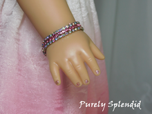 Load image into Gallery viewer, 18 inch doll shown wearing a Pink Shimmer Bracelet with two strands of Aurora Borealis rhinestones on either side of a sparkling pink rhinestone strand
