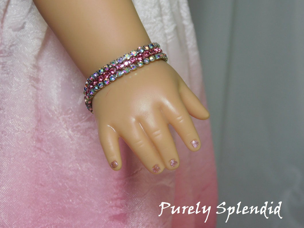 18 inch doll shown wearing a Pink Shimmer Bracelet with two strands of Aurora Borealis rhinestones on either side of a sparkling pink rhinestone strand