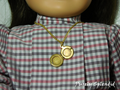 Gold locket on a chain worn by an 18 inch doll - locket is plain inside