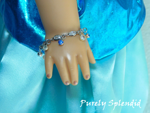 Load image into Gallery viewer, crystal bracelet with alternating light blue and clear crystal dangles shown worn by an 18 inch doll
