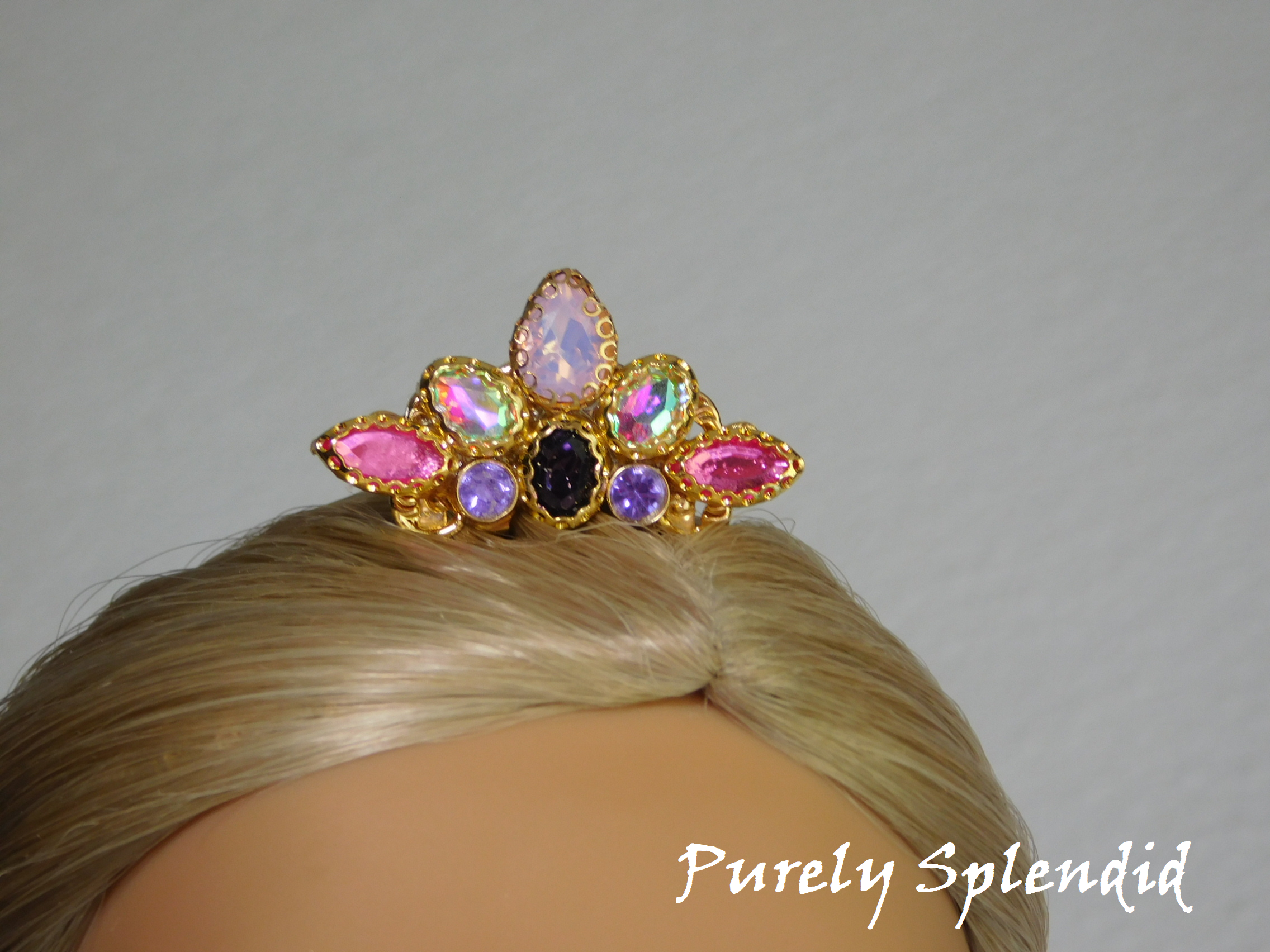 Rapunzel Mini Crown shown on an 18 inch doll. Pink, purple, aurora borealis and opal crystals