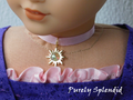 18 inch doll shown wearing Rapunzel Choker Necklace featuring an 18KG plated sun with an large sparkling Aurora Borealis center crystal on a pink satin ribbon