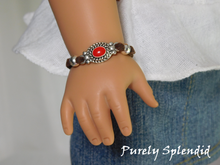 Load image into Gallery viewer, 18 inch doll shown wearing a brown bracelet with an oval red and silver focal point 
