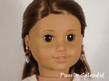 18 inch doll shown wearing a pair of earrings with Rose Gold loops and 3 silver dangles