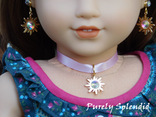 Load image into Gallery viewer, 18 inch doll shown wearing Rapunzel Earring Dangles featuring a 18KG plated sun with an large sparkling Aurora Borealis center crystal along with a pair of 2mm Aurora Borealis crystal studs and a  matching choker necklace
