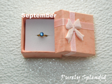 Load image into Gallery viewer, September Birthstone Ring for 18 inch dolls - Sapphire colored crystal on a gold band
