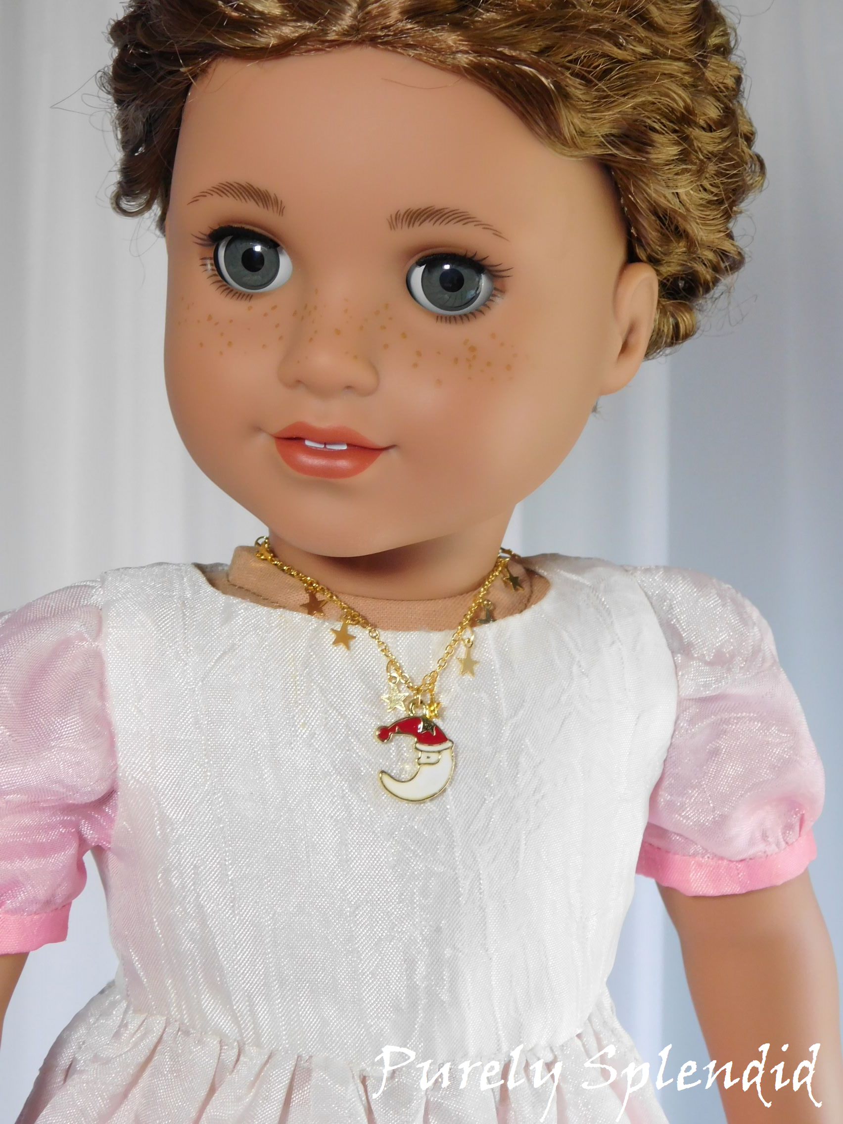18 inch doll wearing a Santa Necklace 