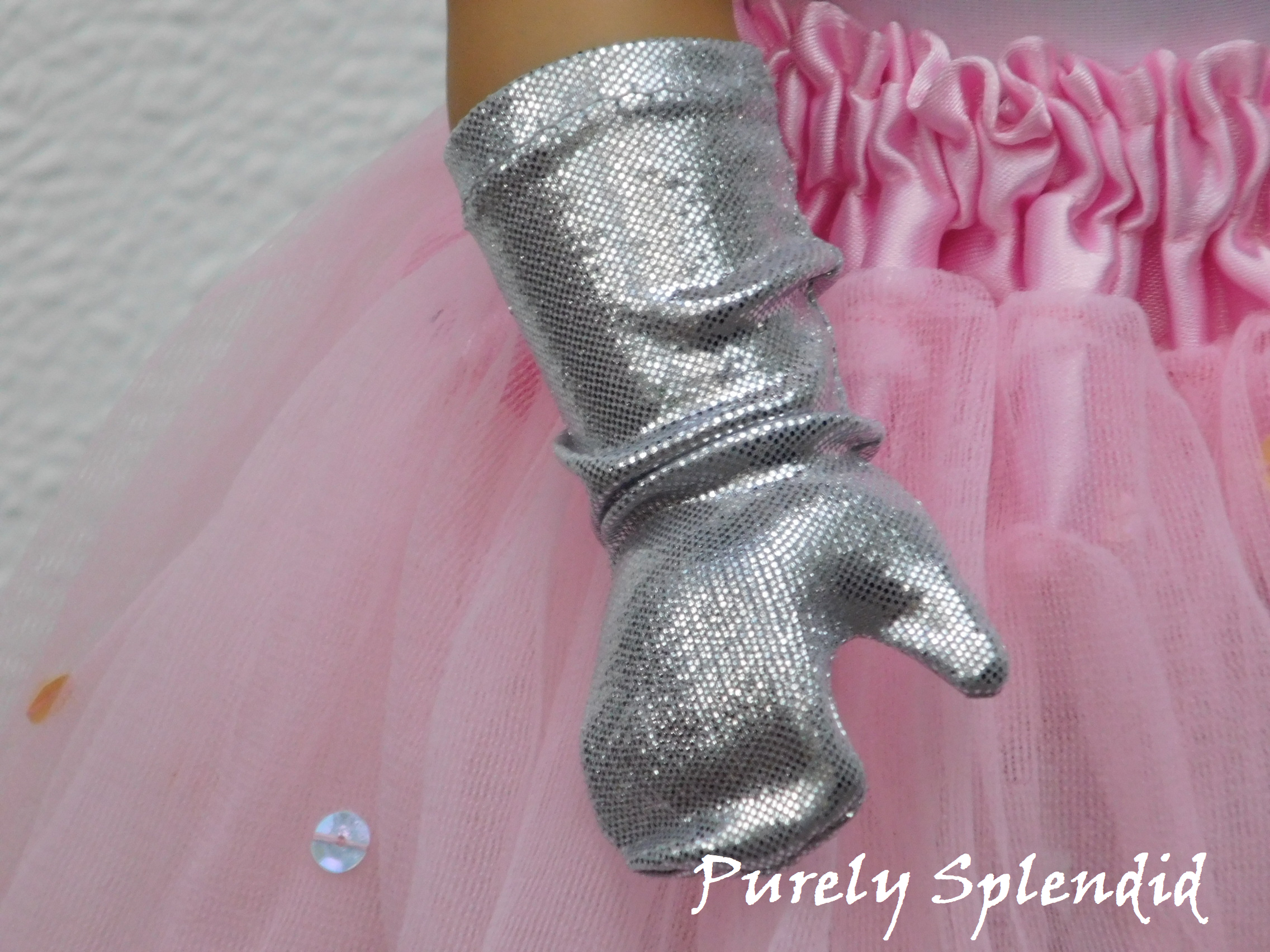 Right hand of an 18 inch doll shown wearing Silver Shimmer Gloves 