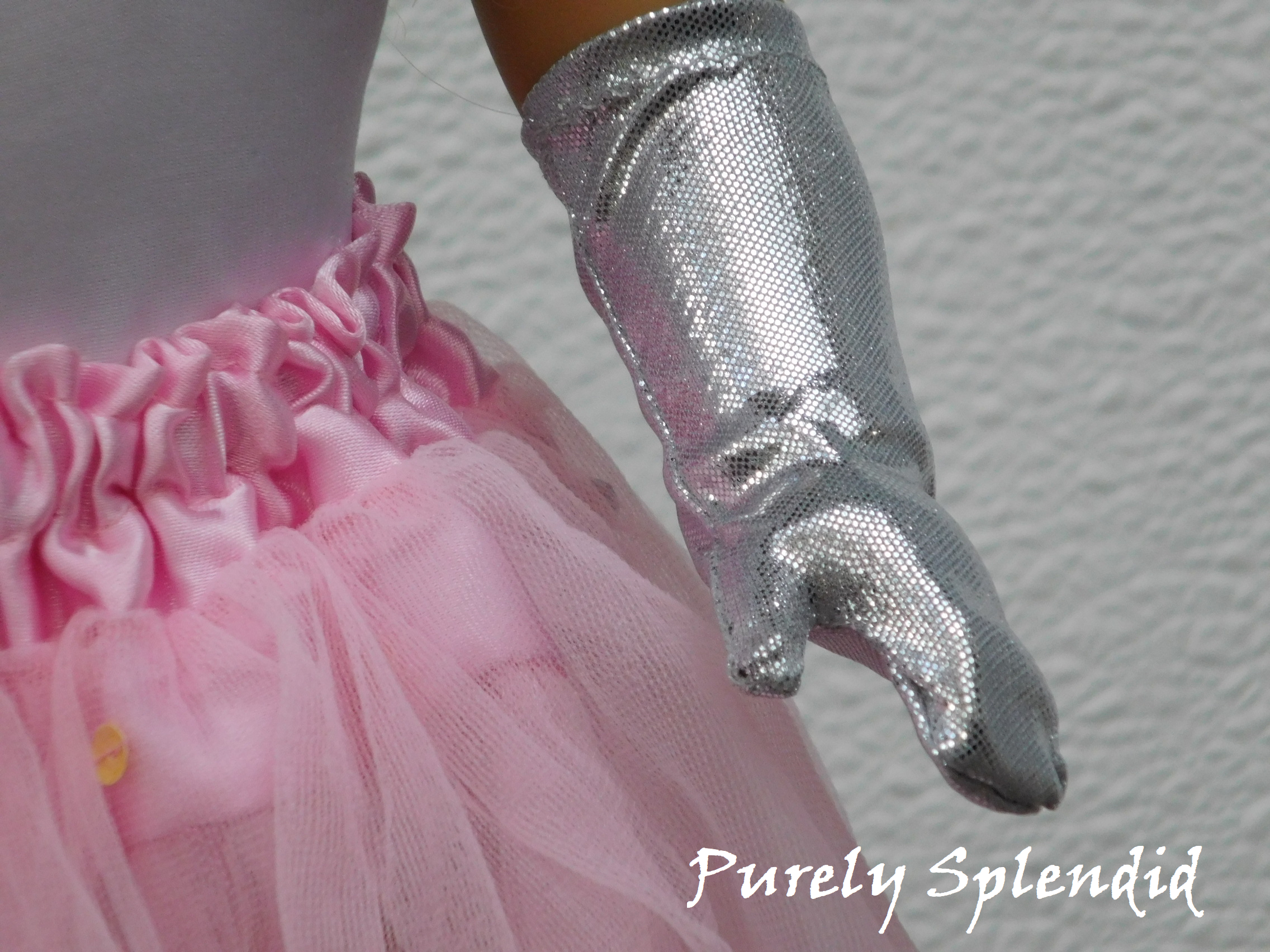 Left hand of an 18 inch doll wearing Silver Shimmer Gloves