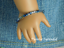Load image into Gallery viewer, 18 inch doll shown wearing a Sparkling Blue Stacking Bracelet
