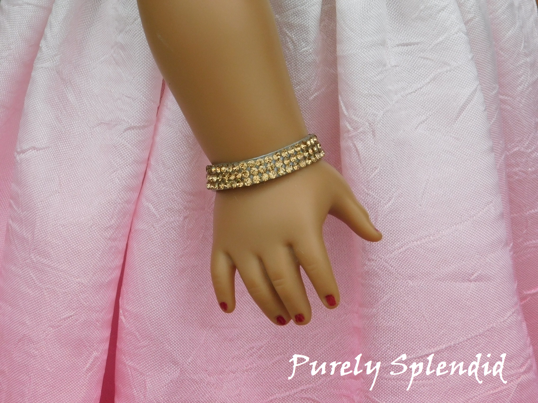 Three rows of sparkling gold rhinestones make up this Sparkling Gold Rhinestone Bracelet