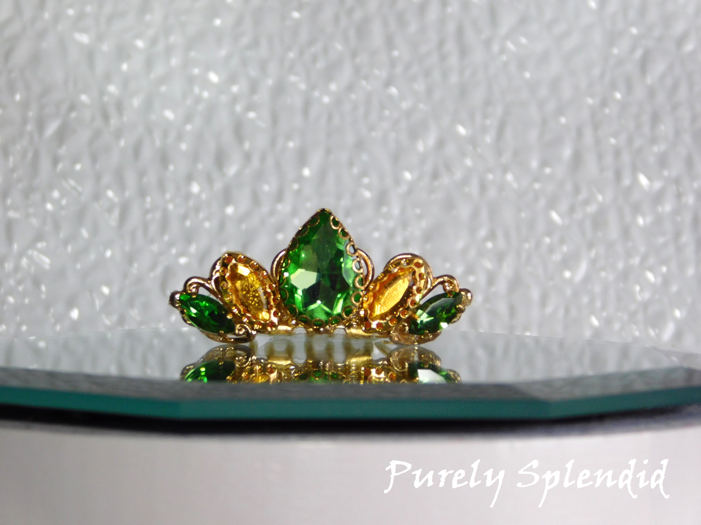 Peridot and gold colored crystals make up this pretty Tiana Crown for dolls