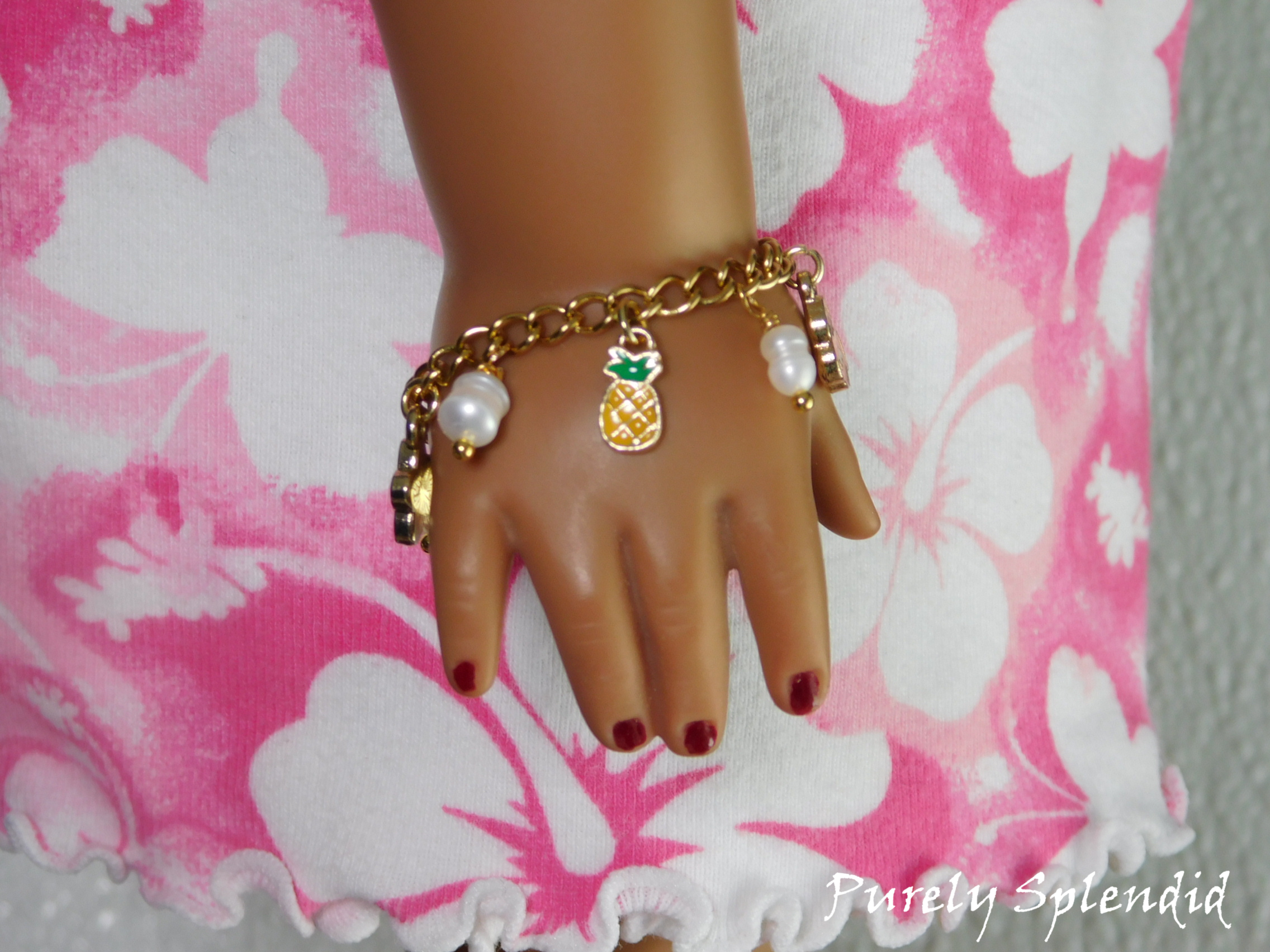 Tropical Charm Bracelet worn by an 18 inch doll featuring freshwater pearls and a pineapple charm