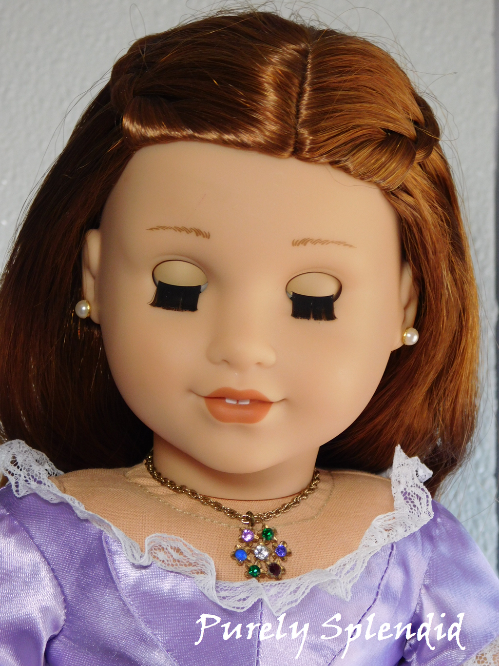 18 inch doll wearing flower necklace with colorful gemstones