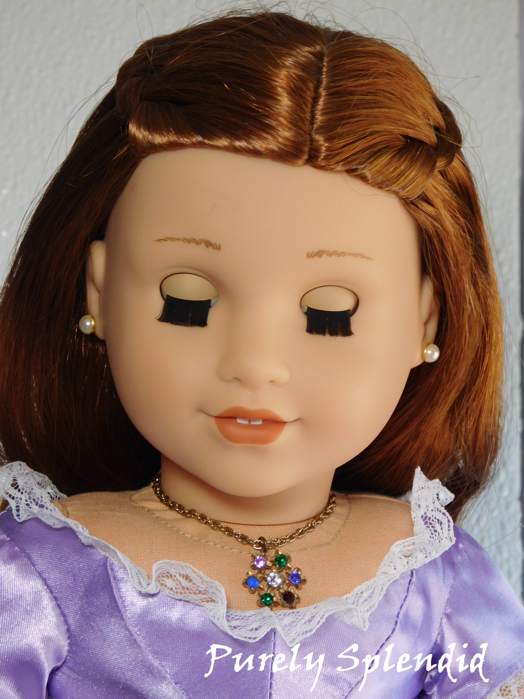 18 inch doll wearing flower necklace with colorful gemstones