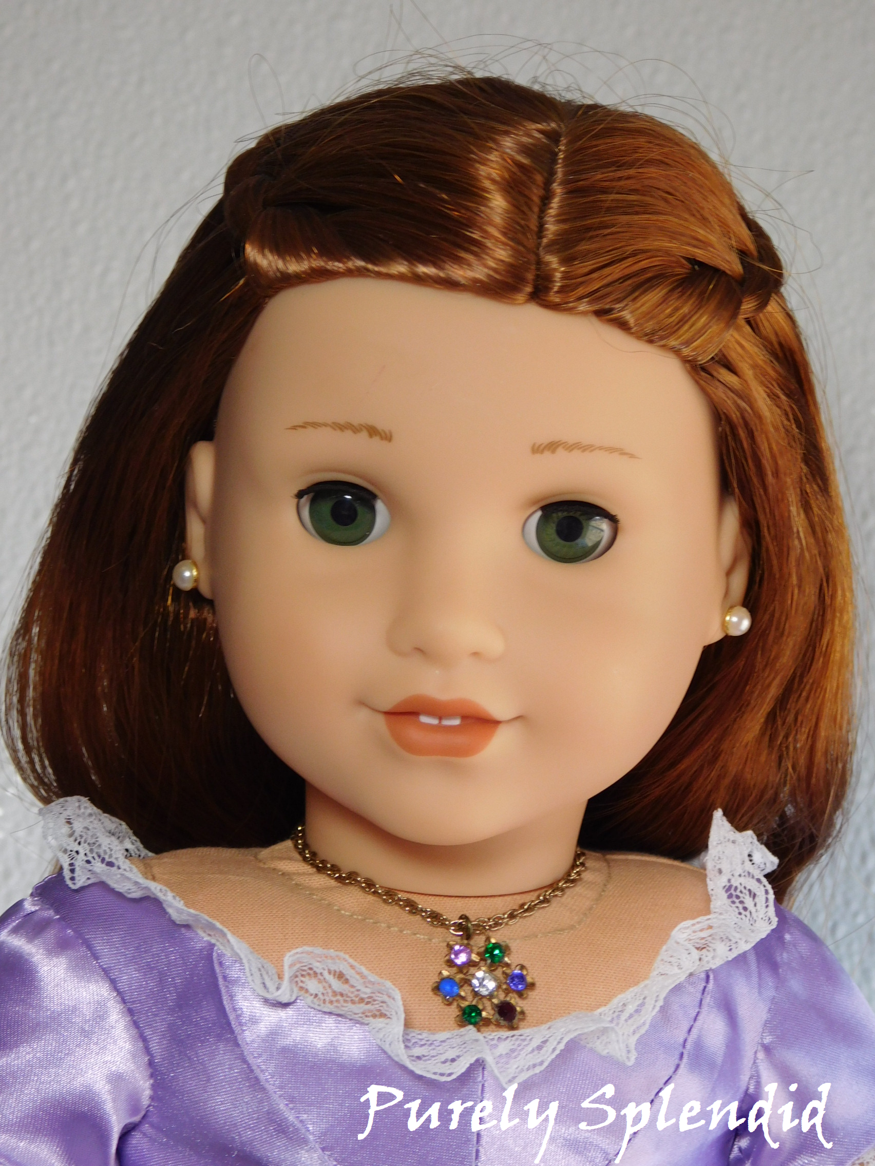 18 inch doll wearing a gemstone necklace that spells the word Dearest