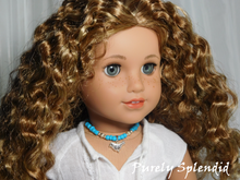 Load image into Gallery viewer, 18 inch doll shown wearing a blue and silver beaded necklace with a silver bird pendant
