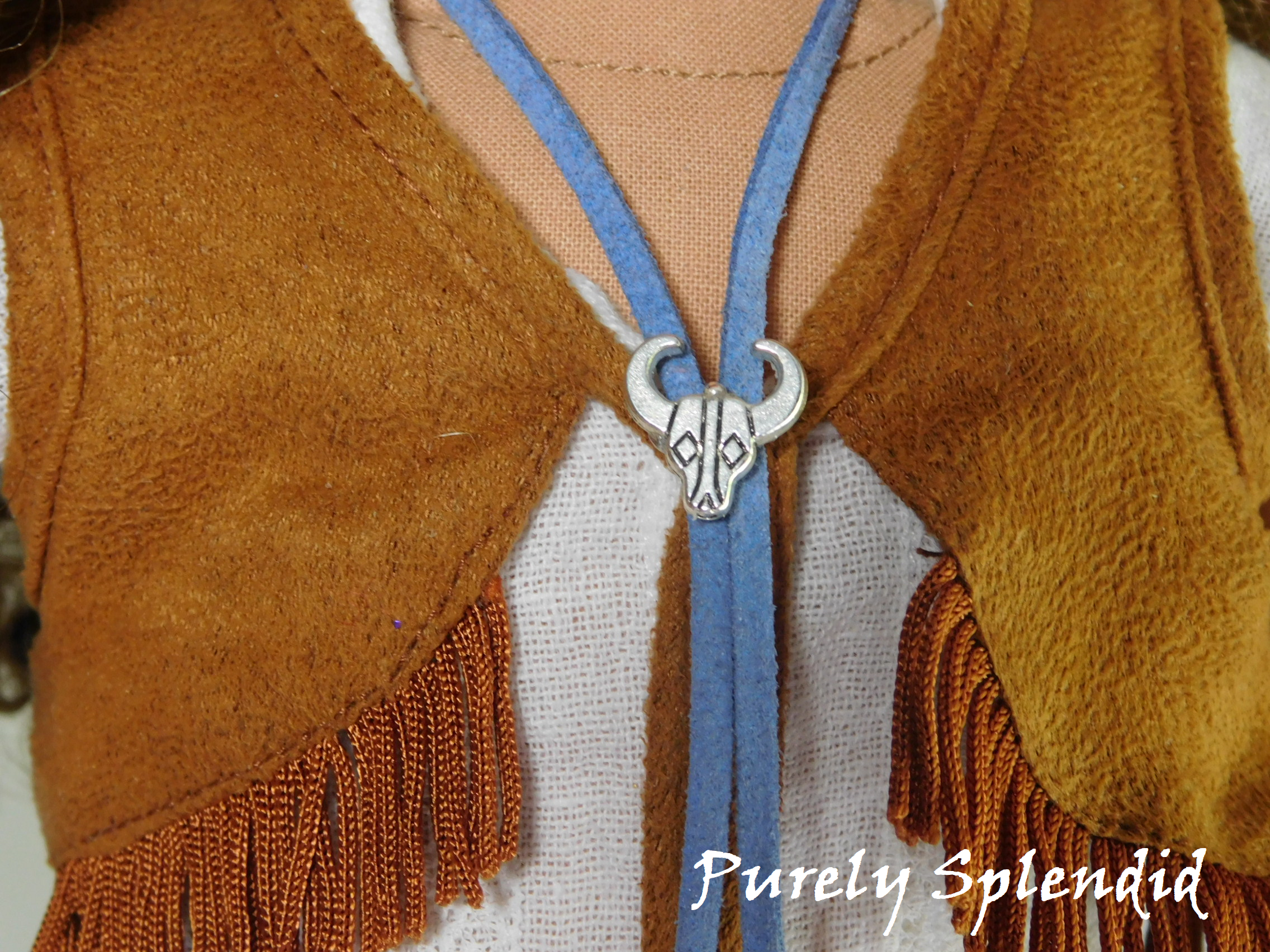 18 inch doll shown wearing the blue Western Bolo with silver steer head