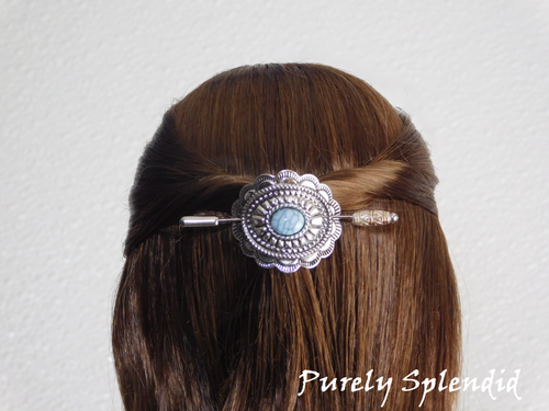 Doll shown with a small section of hair that is captured in the silver concho barrette and secured with a hair stick