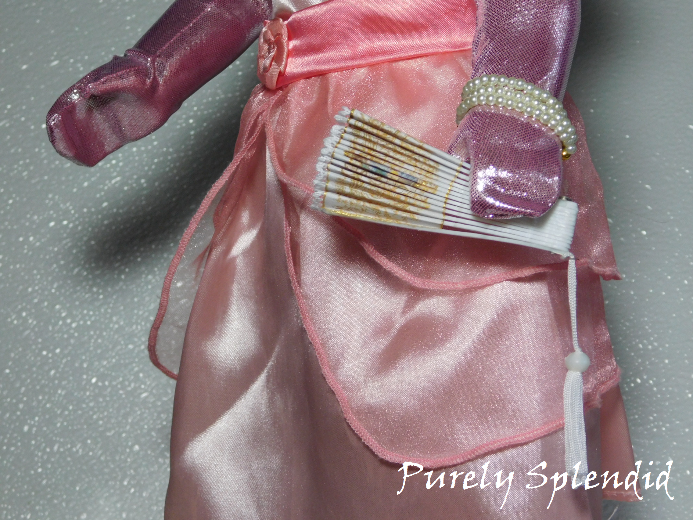 18 inch doll shown holding a White and Gold Hand Fan