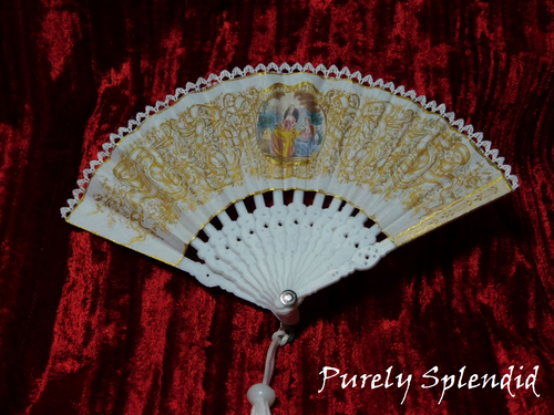 opened White and Gold Hand Fan