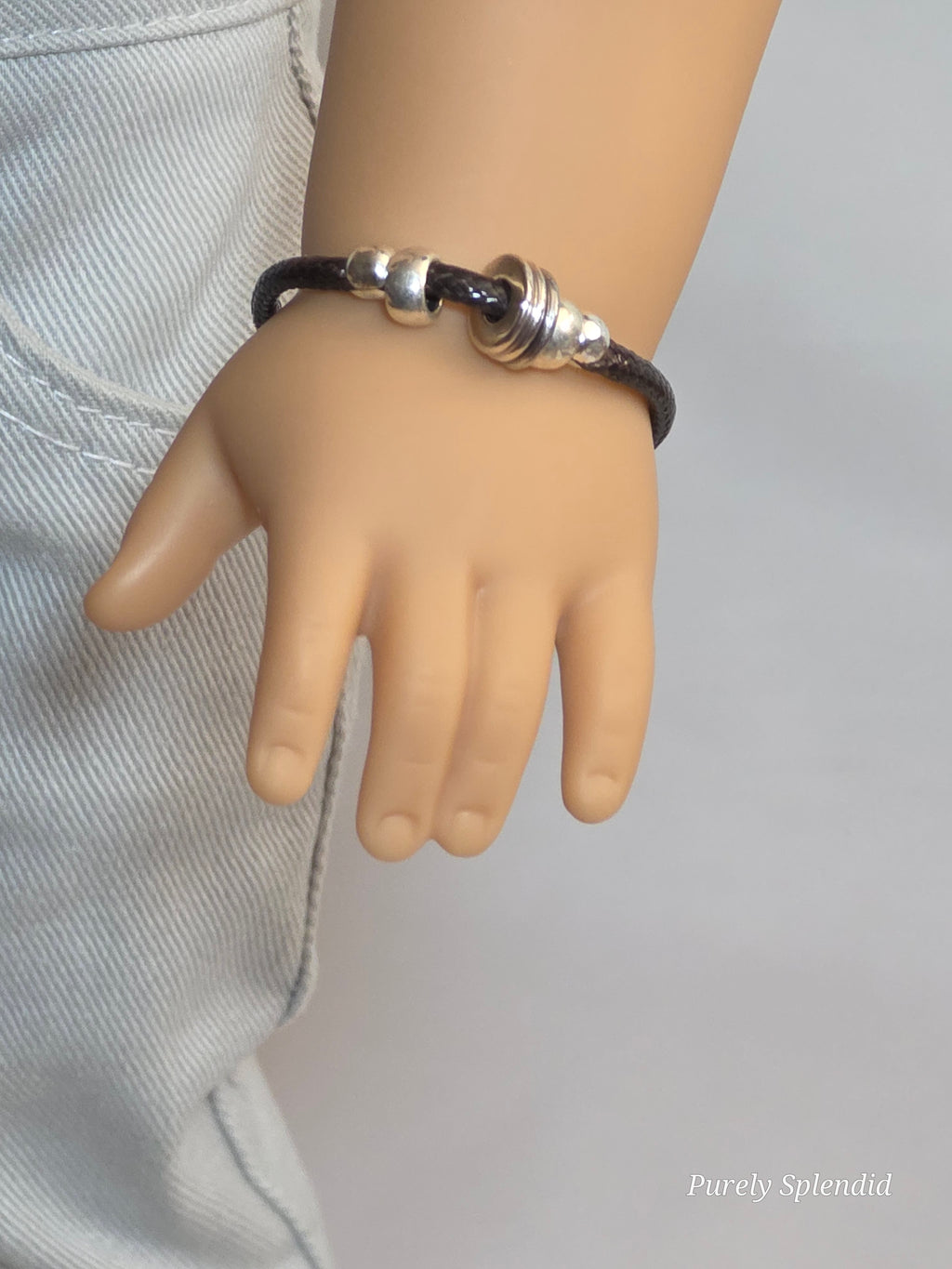 18 inch boy doll wearing a fresh silver and brown bracelet / American made / Purely Splendid