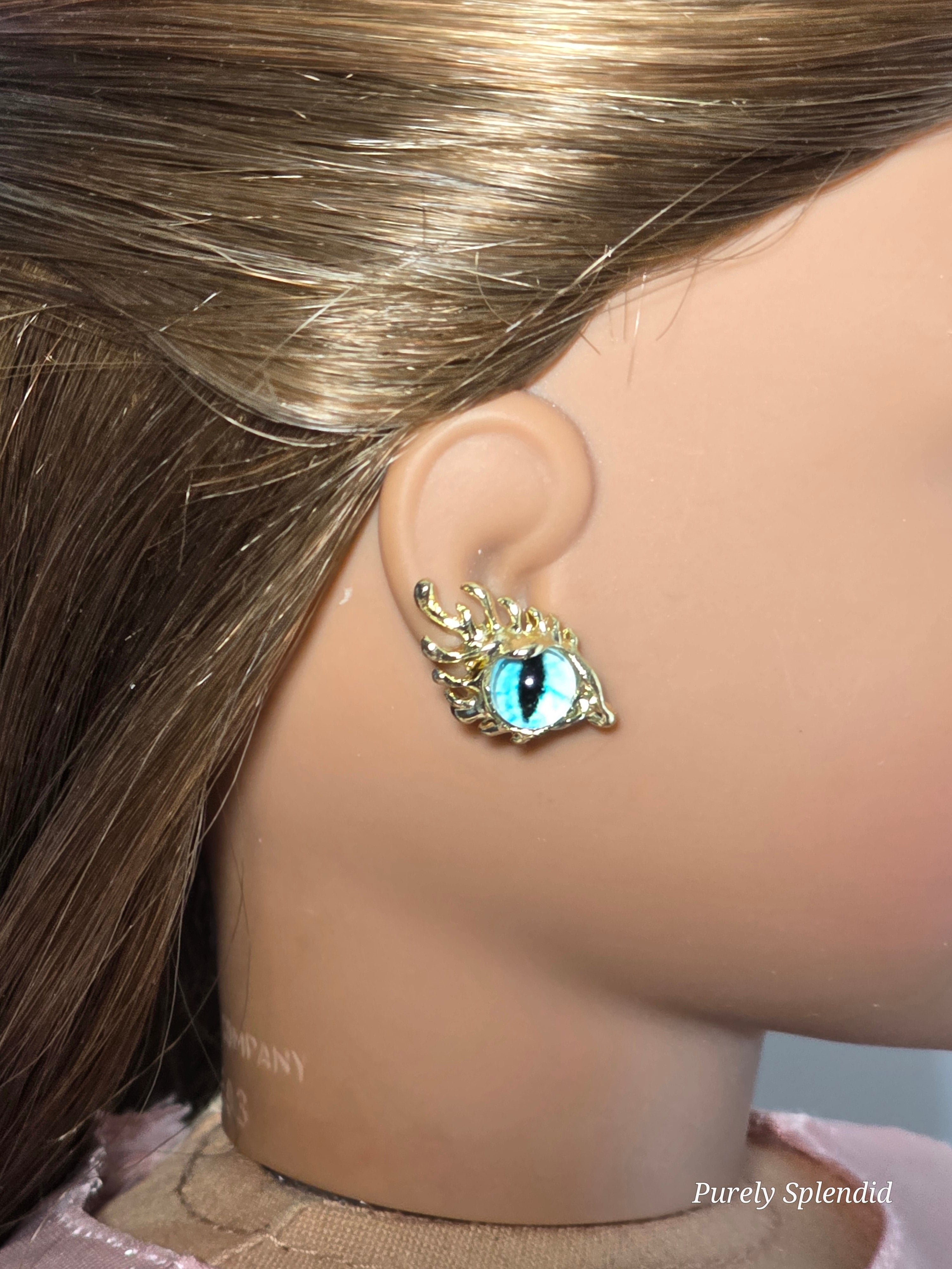 18 inch doll wearing a pair of blue eye studs with fancy lashes