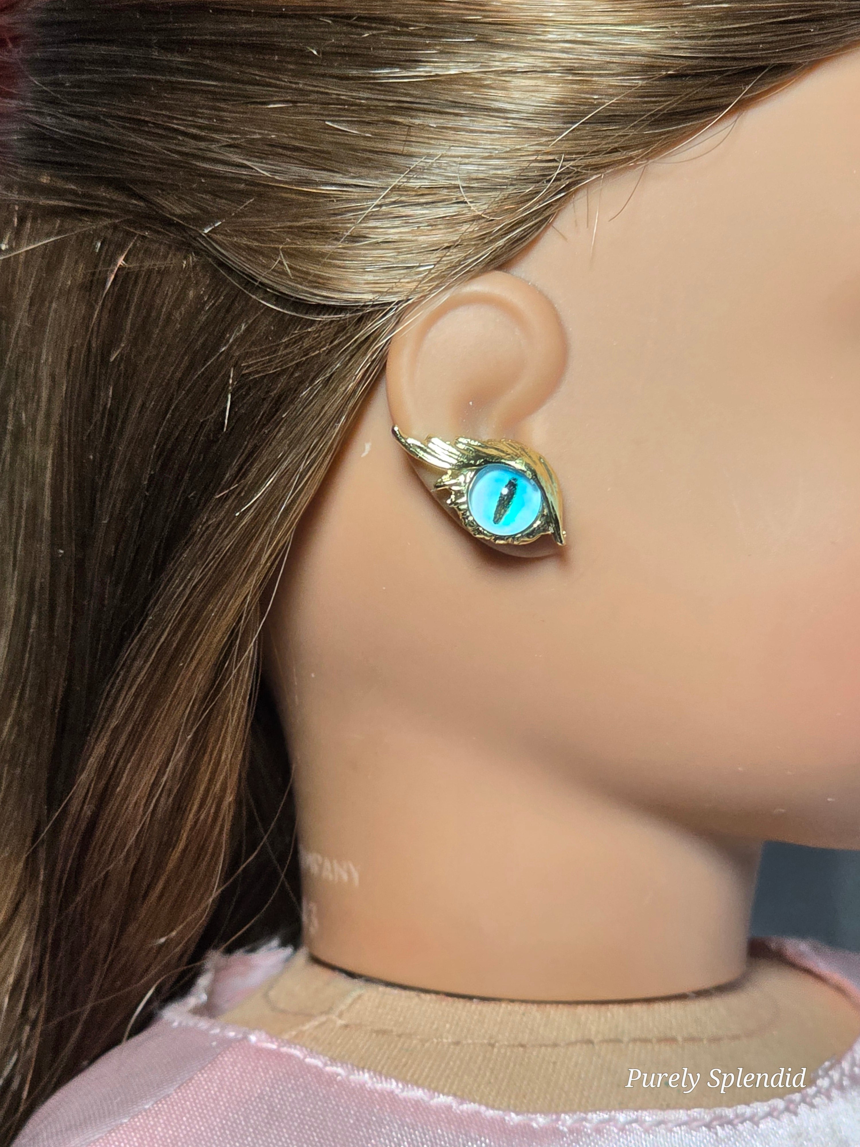 18 inch doll wearing a pair of blue eye studs